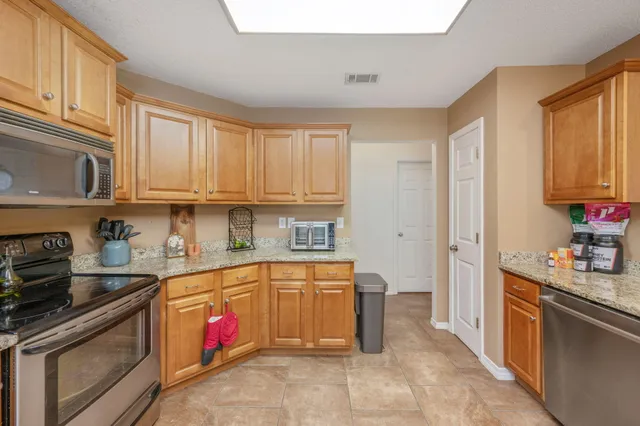 a kitchen with stainless steel appliances granite countertop a refrigerator and sink