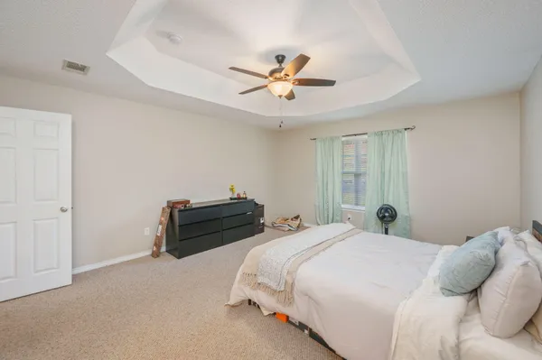 a bedroom with a bed and a ceiling fan
