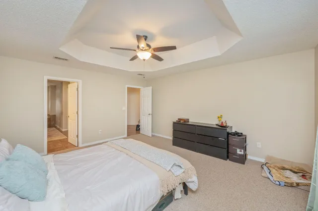 a bed room with a bed and a chandelier