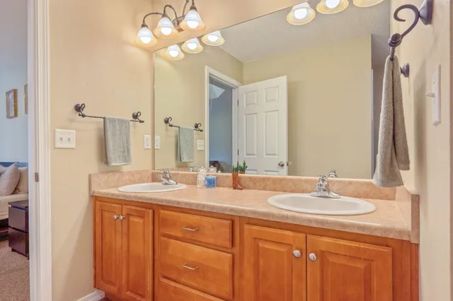 a bathroom with a double vanity sink and a mirror