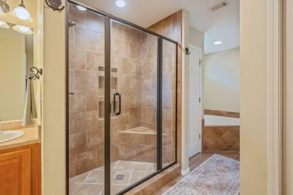 a bathroom with a glass shower door