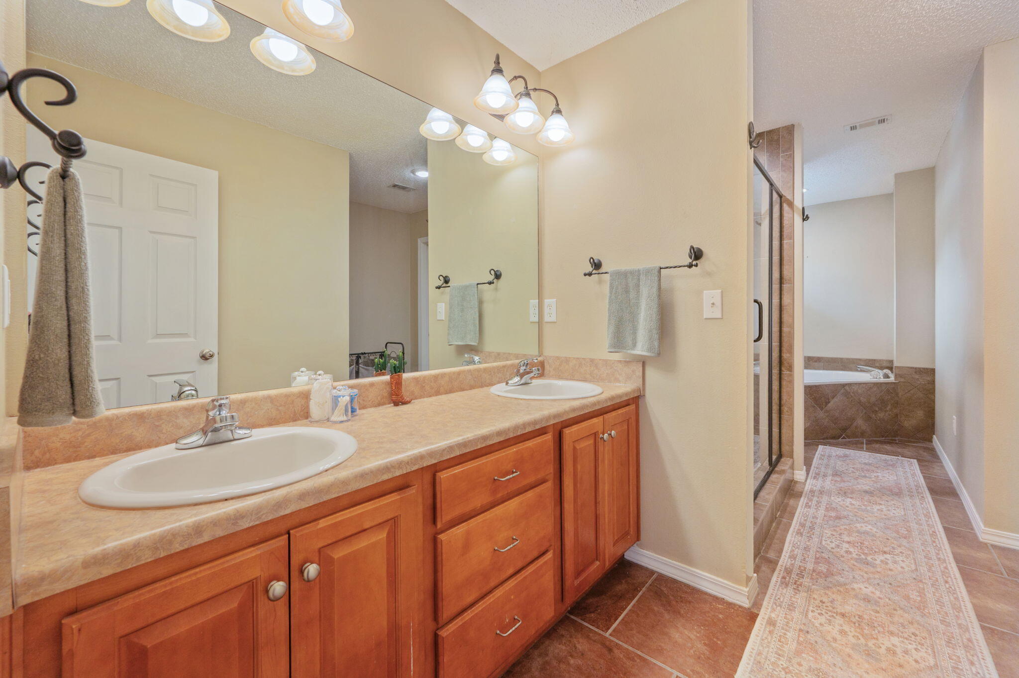 109 Tranquility Drive Crestview, FL 32536 - Photo 26 of 41 a bathroom with a granite countertop sink a large mirror and a shower