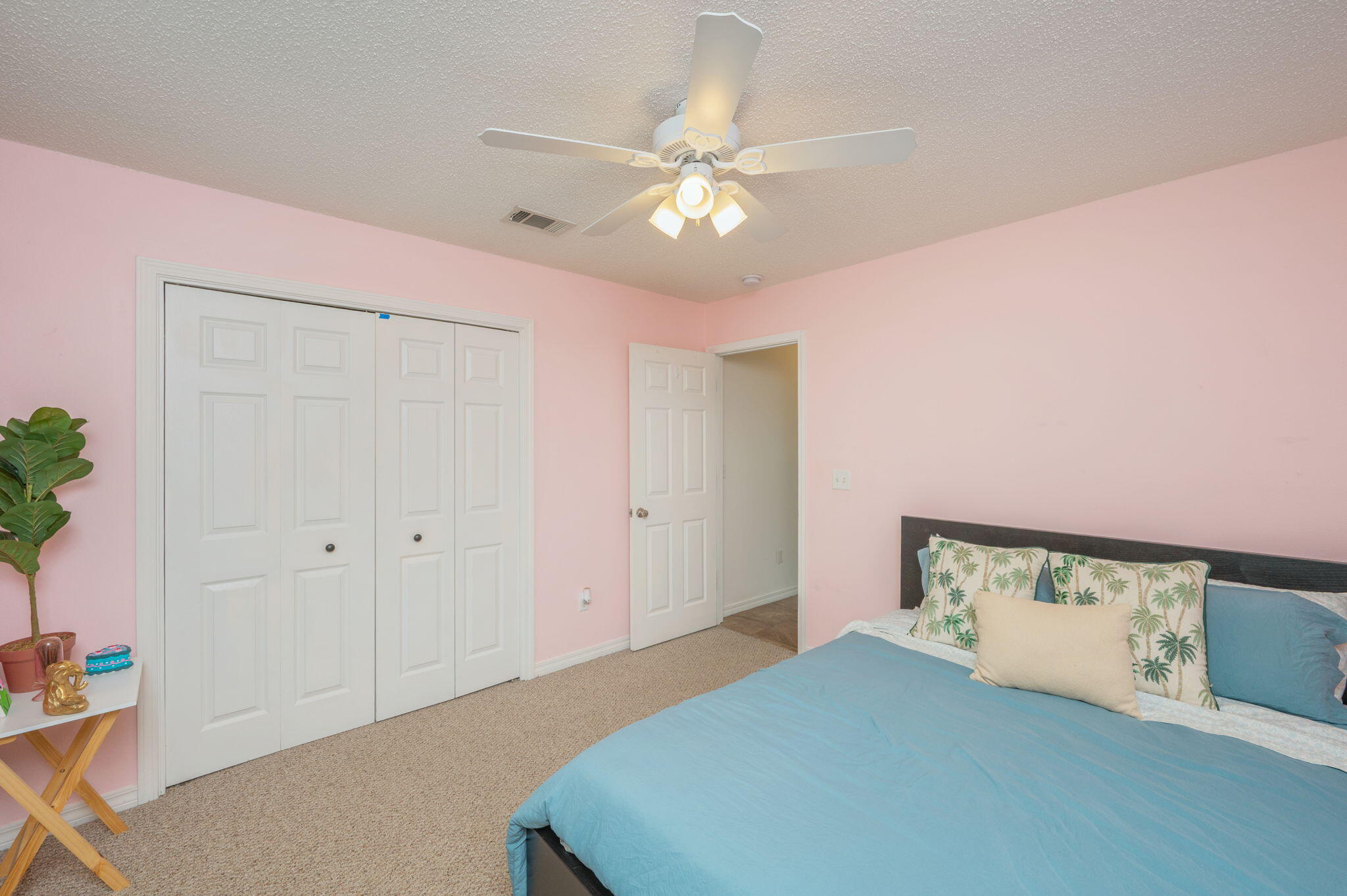 109 Tranquility Drive Crestview, FL 32536 - Photo 29 of 41 a bedroom with a bed and a potted plant