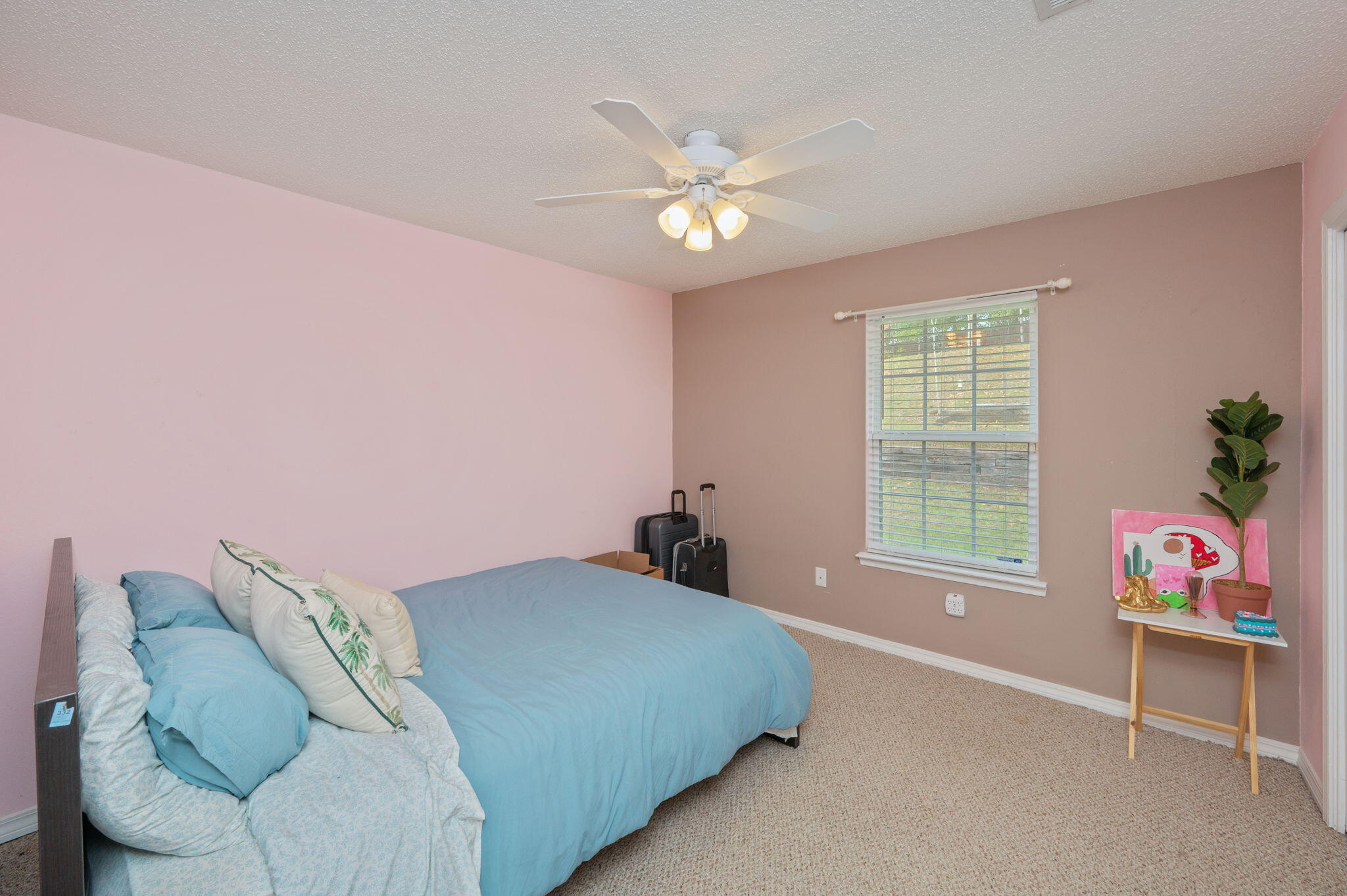 109 Tranquility Drive Crestview, FL 32536 - Photo 30 of 41 a bedroom with a bed and a chandelier