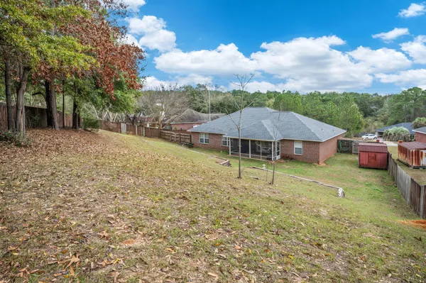 a backyard of a house with table and chairs
