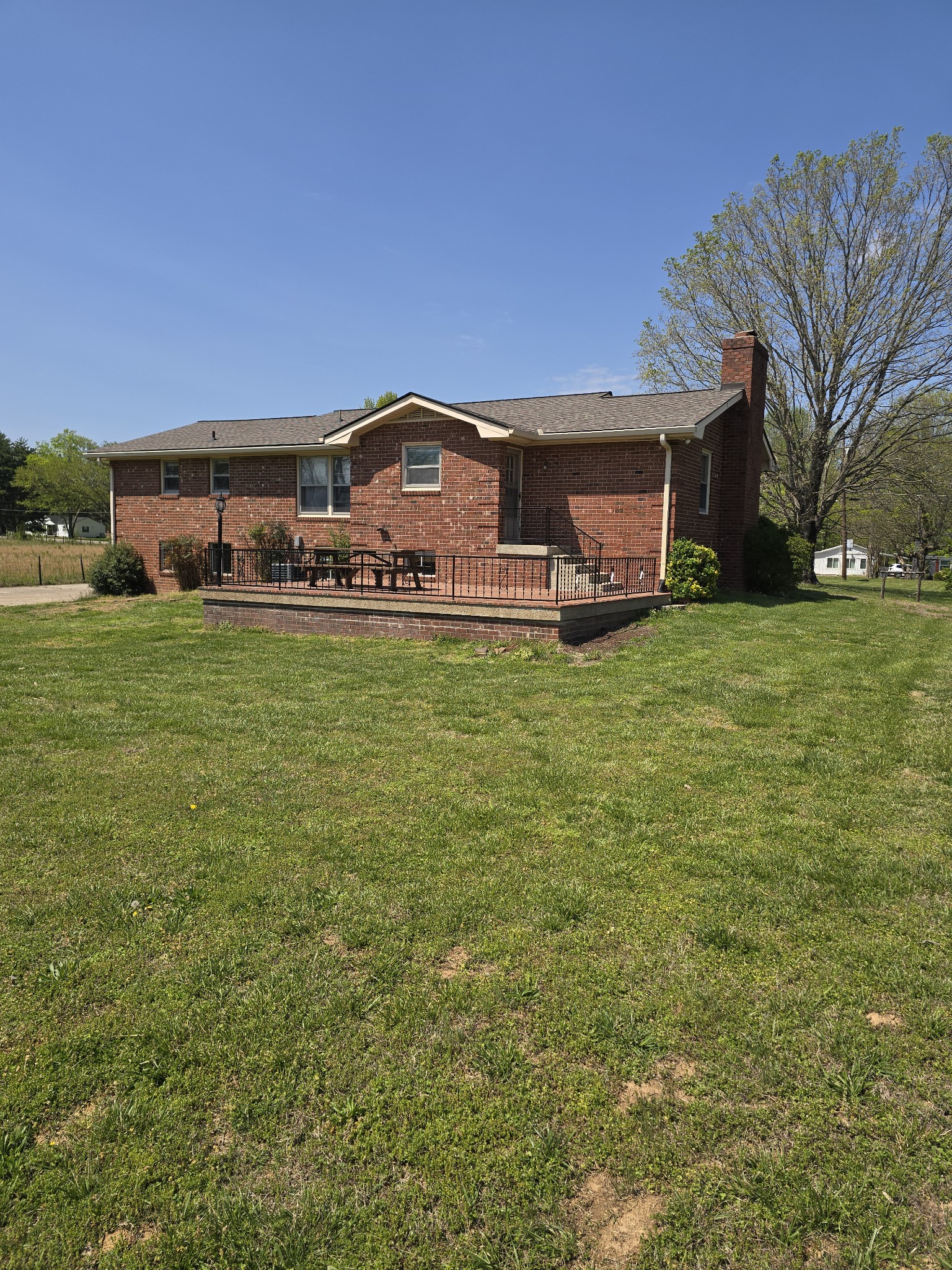 6350 Eatons Creek Road Joelton, TN 37080 - Photo 11 of 37 a front view of a house with a garden and deck