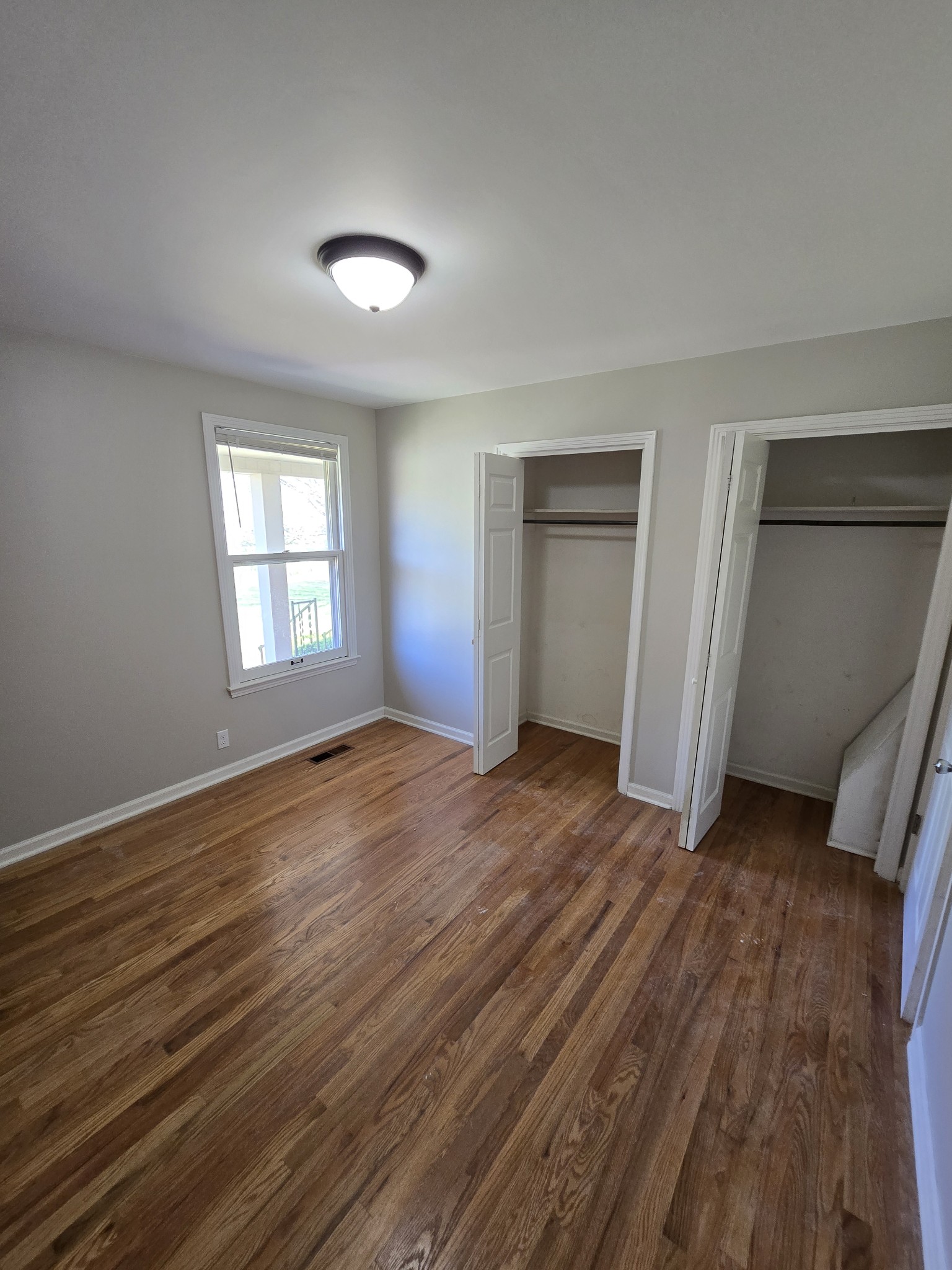 6350 Eatons Creek Road Joelton, TN 37080 - Photo 25 of 37 an empty room with wooden floor and windows