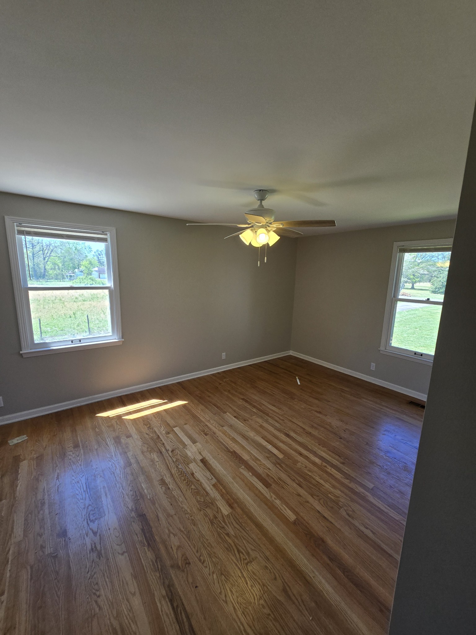 6350 Eatons Creek Road Joelton, TN 37080 - Photo 26 of 37 an empty room with wooden floor and windows