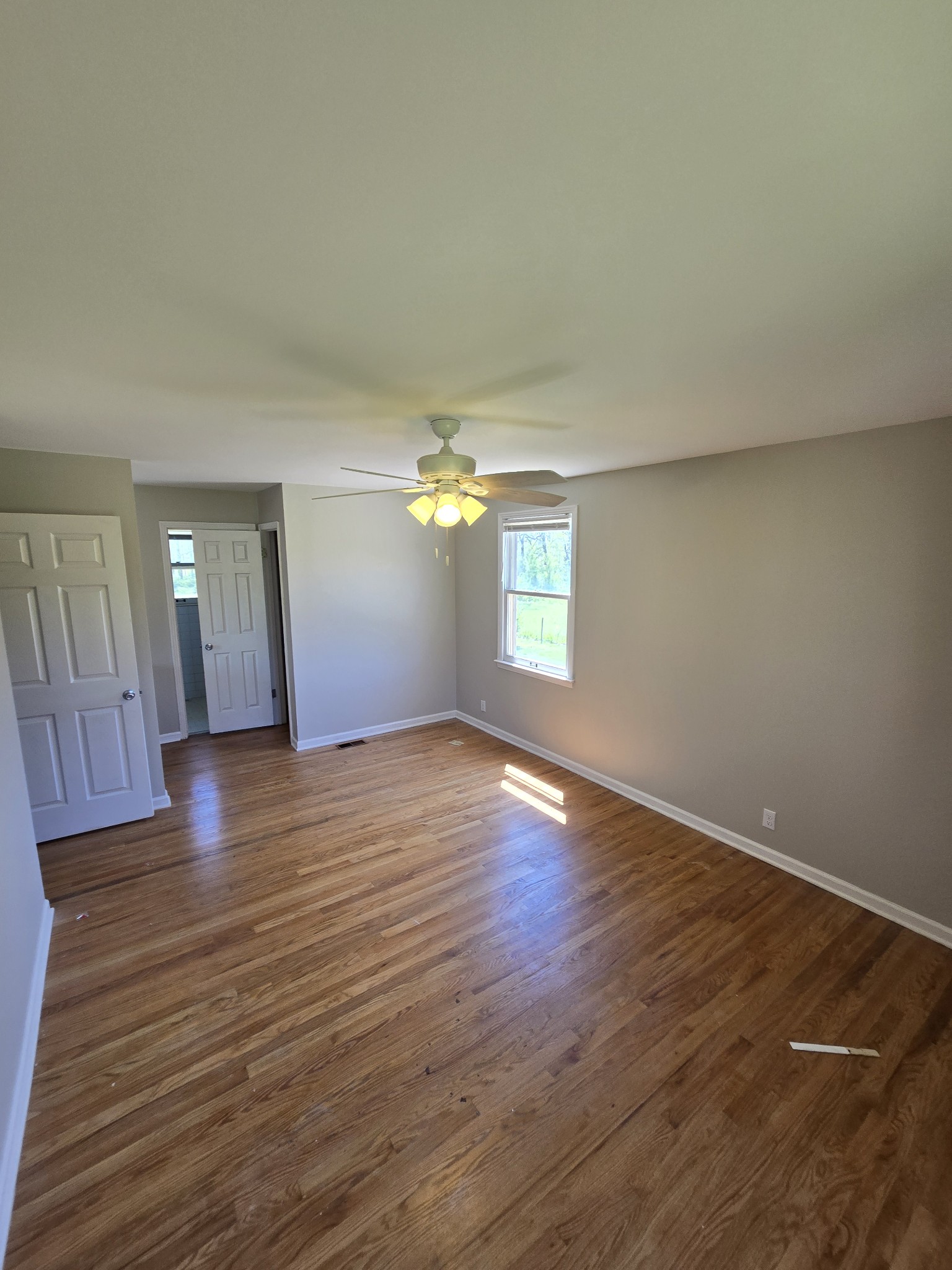 6350 Eatons Creek Road Joelton, TN 37080 - Photo 27 of 37 a view of empty room with wooden floor and fan