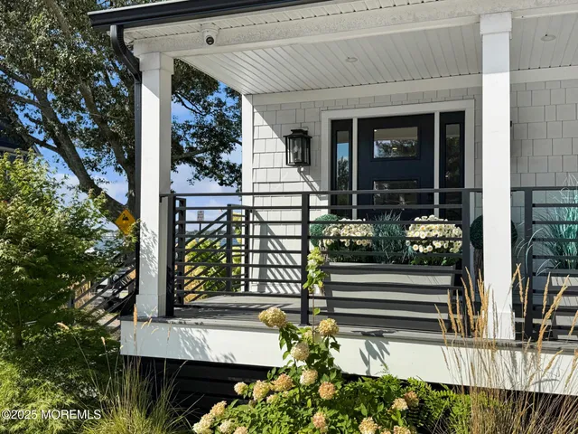 a flower garden is sitting in front of a house