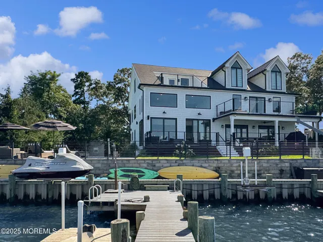 a view of a swimming pool with table and chairs under an umbrella