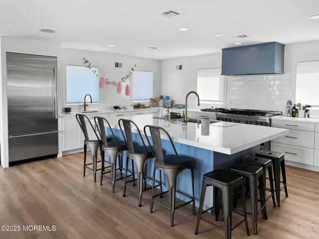 a kitchen with a stove and white cabinets