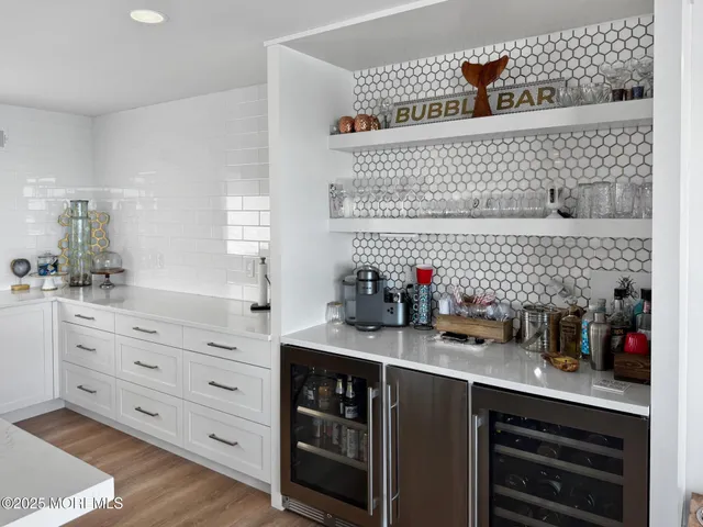 a kitchen with kitchen island a sink and a stove