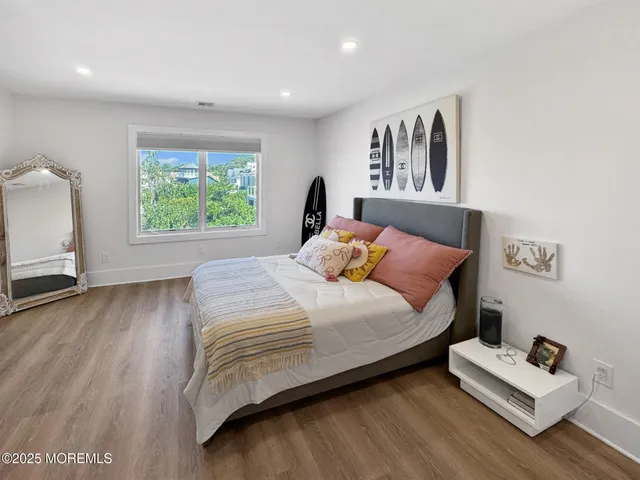 a view of a swimming pool with lawn chairs under an umbrella