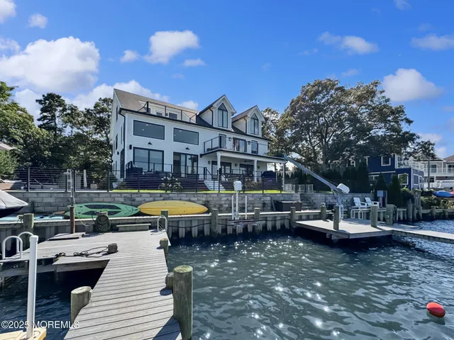 a view of a house with swimming pool and sitting area