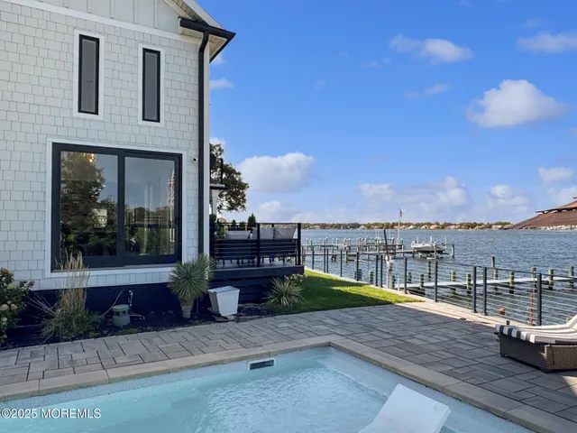 a view of roof deck with a barbeque and wooden floor