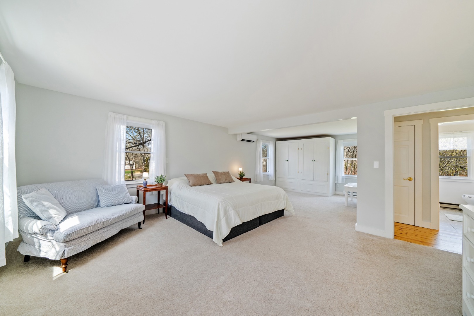 357 West Tisbury Road Edgartown, MA 02539 - Photo 11 of 33 a spacious bedroom with a bed and a couch