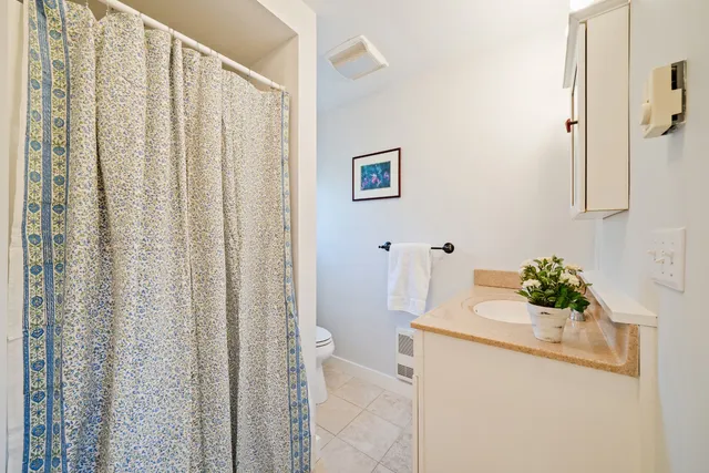 a bath room with a sink and mirror