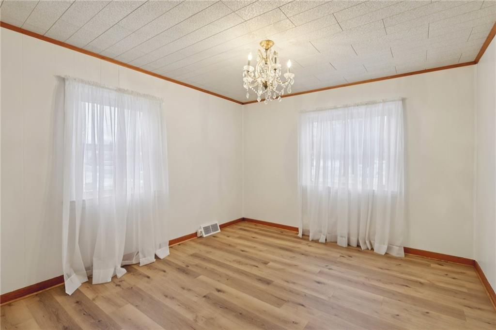 1111 Crowe Street New Castle, PA 16101 - Photo 12 of 37 a view of empty room with wooden floor and chandelier
