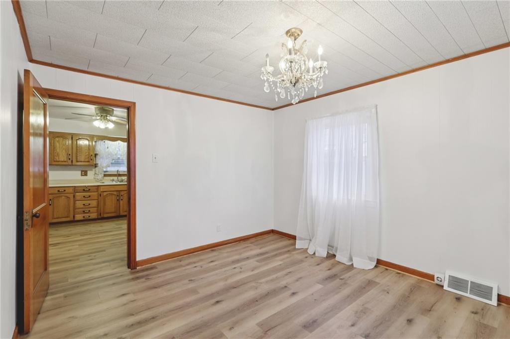 1111 Crowe Street New Castle, PA 16101 - Photo 13 of 37 a view of a hallway with wooden floor and a chandelier