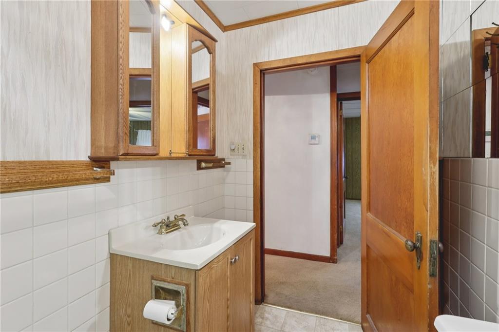 1111 Crowe Street New Castle, PA 16101 - Photo 16 of 37 a bathroom with a sink and a mirror