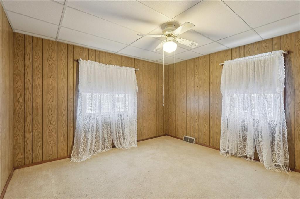 1111 Crowe Street New Castle, PA 16101 - Photo 20 of 37 an empty room with a ceiling fan and a window
