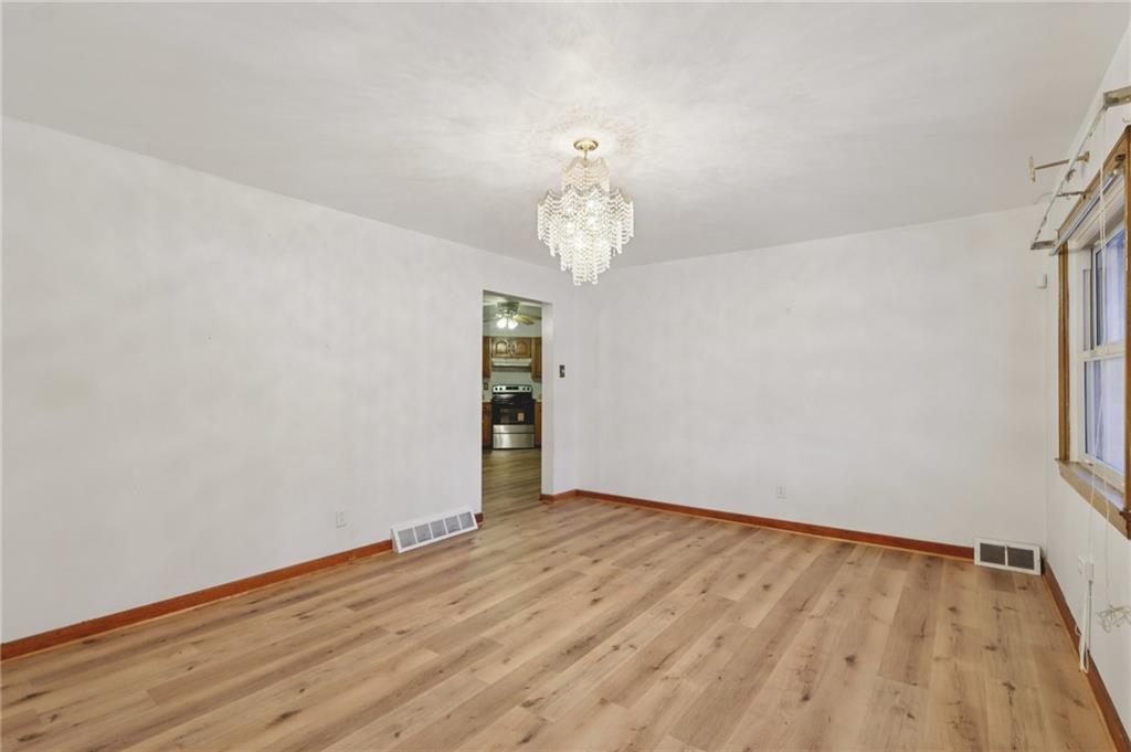1111 Crowe Street New Castle, PA 16101 - Photo 5 of 37 wooden floor in an empty room with a window