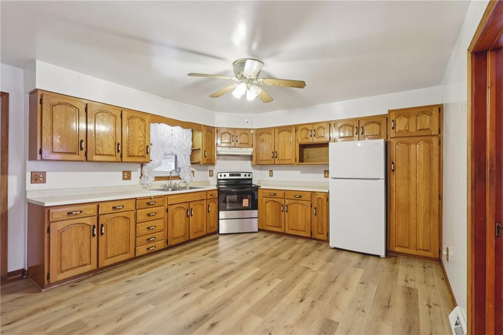 1111 Crowe Street New Castle, PA 16101 - Photo 7 of 37 a large kitchen with wooden floors and stainless steel appliances