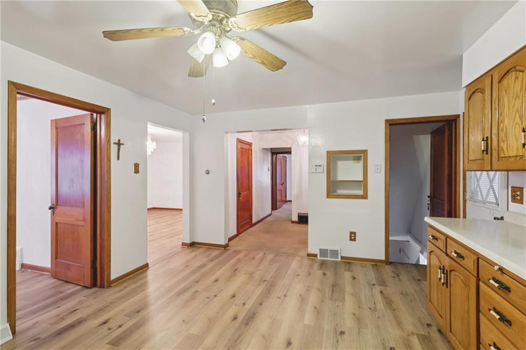 1111 Crowe Street New Castle, PA 16101 - Photo 9 of 37 a view of a kitchen with wooden floor and a ceiling fan
