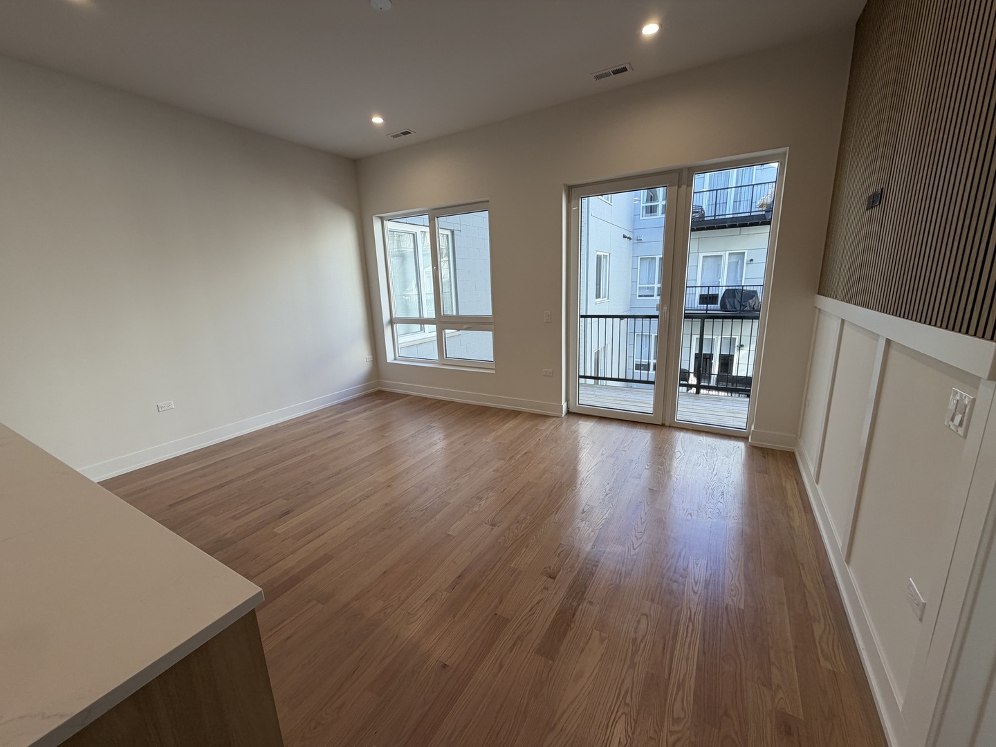 2127 West Madison Street, Unit 409 Chicago, IL 60612 - Photo 7 of 15 wooden floor in an empty room with a window