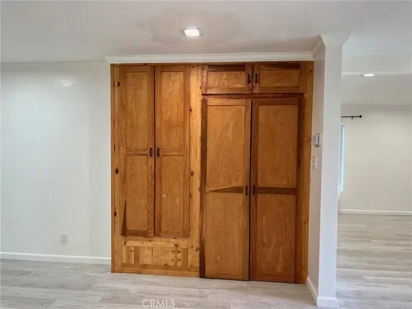 an empty room with wooden floor and a window