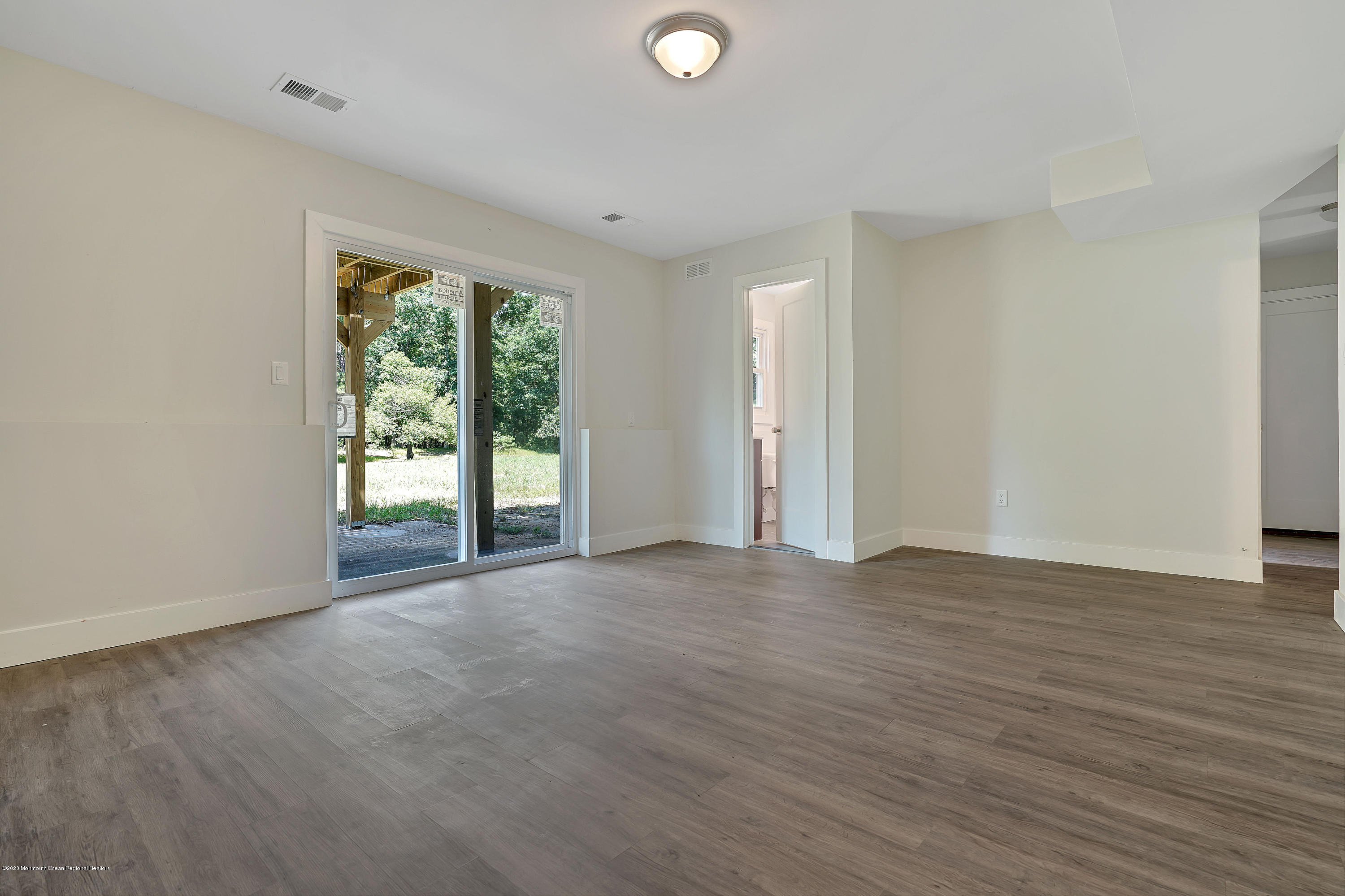 30 Jackson Mills Road Jackson, NJ 08527 - Photo 27 of 37 a view of an empty room with wooden floor and a window