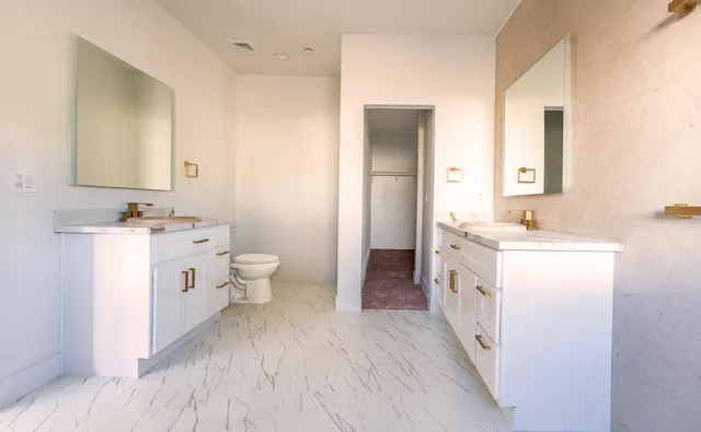 a bathroom with a double vanity sink and mirror