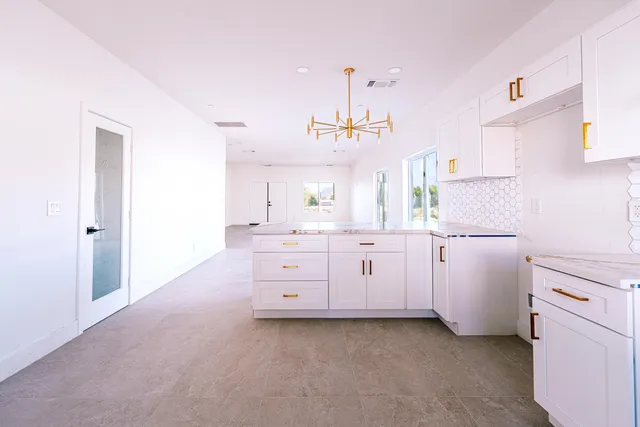 a kitchen with cabinets stainless steel appliances and a window