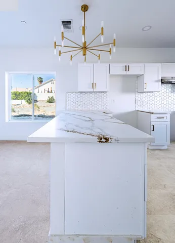 a kitchen with stainless steel appliances granite countertop a sink a stove and dishwasher