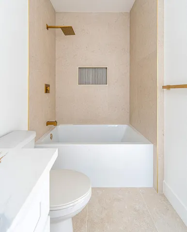 a bathroom with a bathtub and a sink