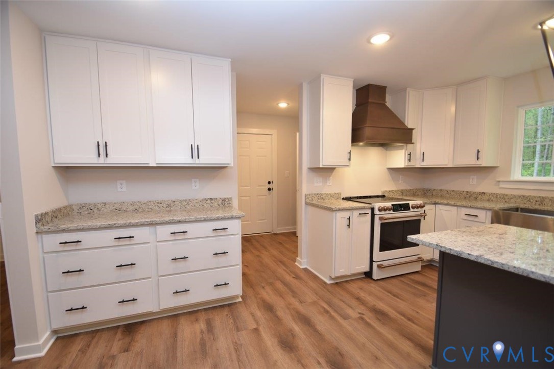 1749 Hollands Road Palmyra, VA 22963 - Photo 9 of 40 Kitchen with white cabinets, white electric range