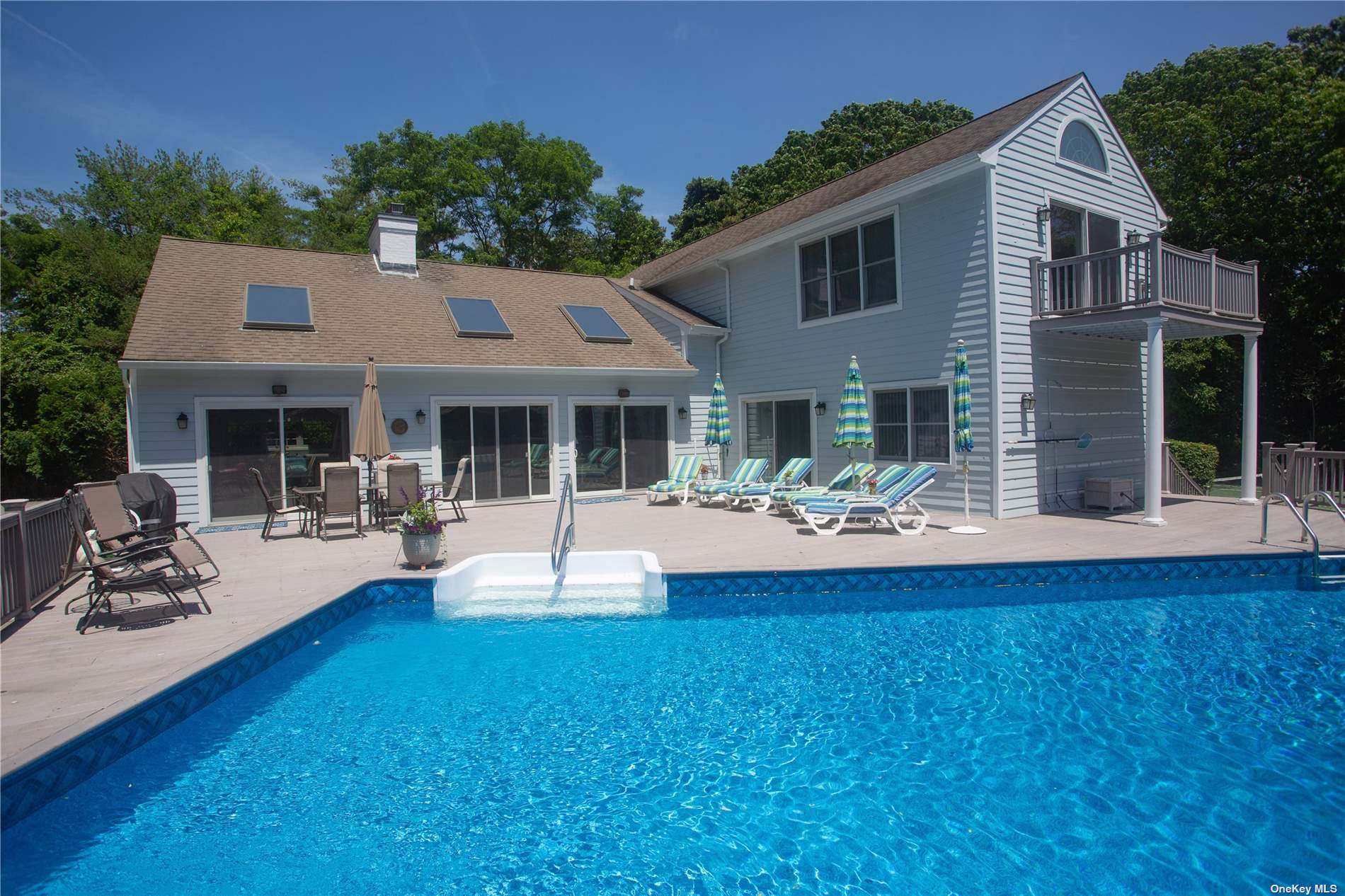 a front view of a house with swimming pool and porch