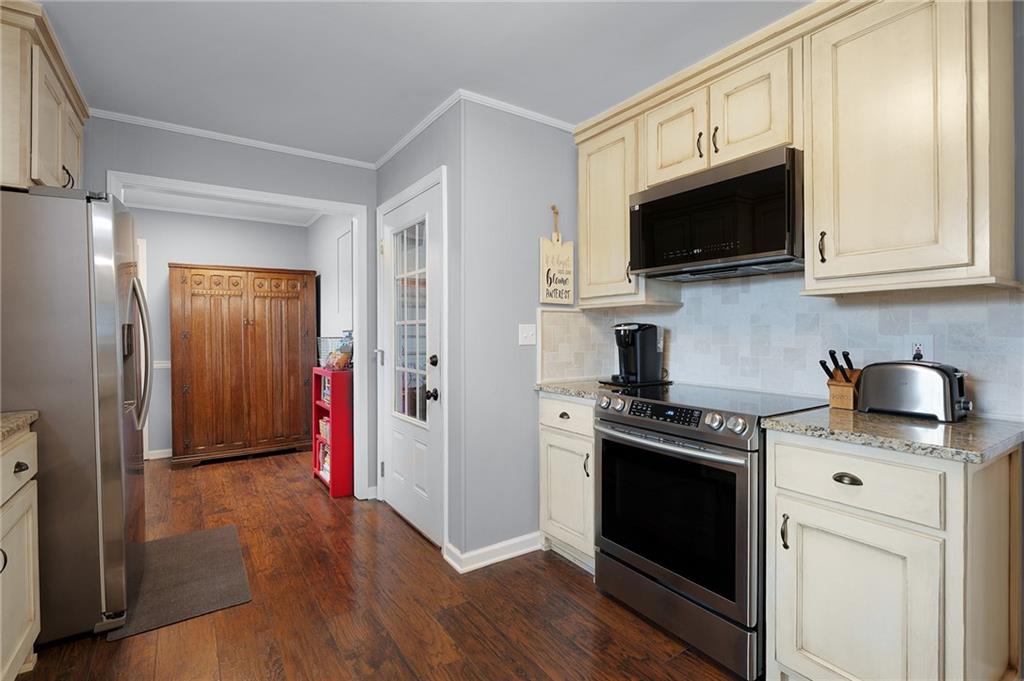 136 Meadow Lane Calhoun, GA 30701 - Photo 12 of 34 a kitchen with stainless steel appliances granite countertop a stove a sink and a microwave