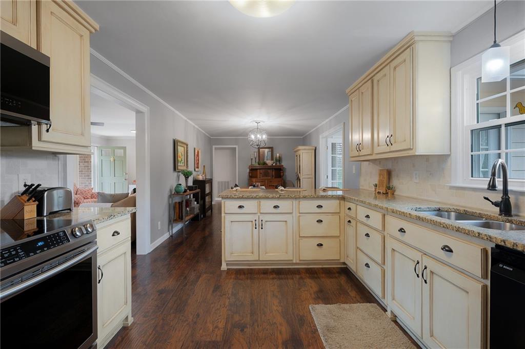 136 Meadow Lane Calhoun, GA 30701 - Photo 13 of 34 a kitchen with granite countertop cabinets stainless steel appliances and a wooden floor