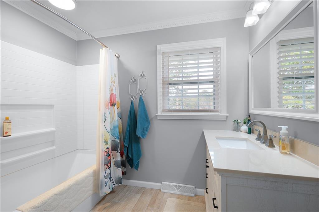 136 Meadow Lane Calhoun, GA 30701 - Photo 19 of 34 a bathroom with a tub sink and a window