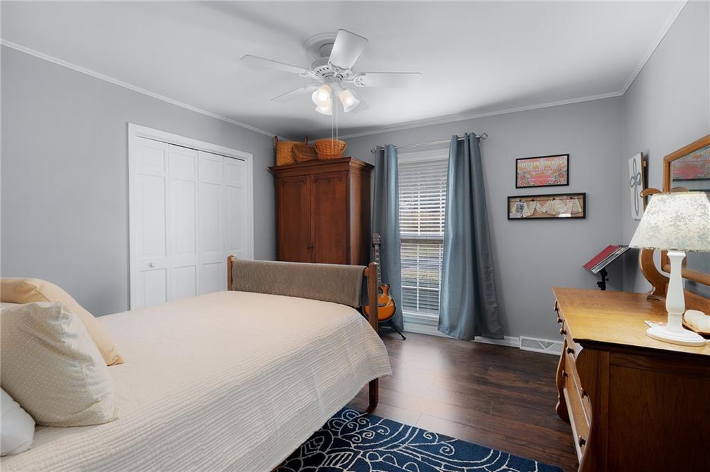 136 Meadow Lane Calhoun, GA 30701 - Photo 20 of 34 a bedroom with a bed and wooden floor