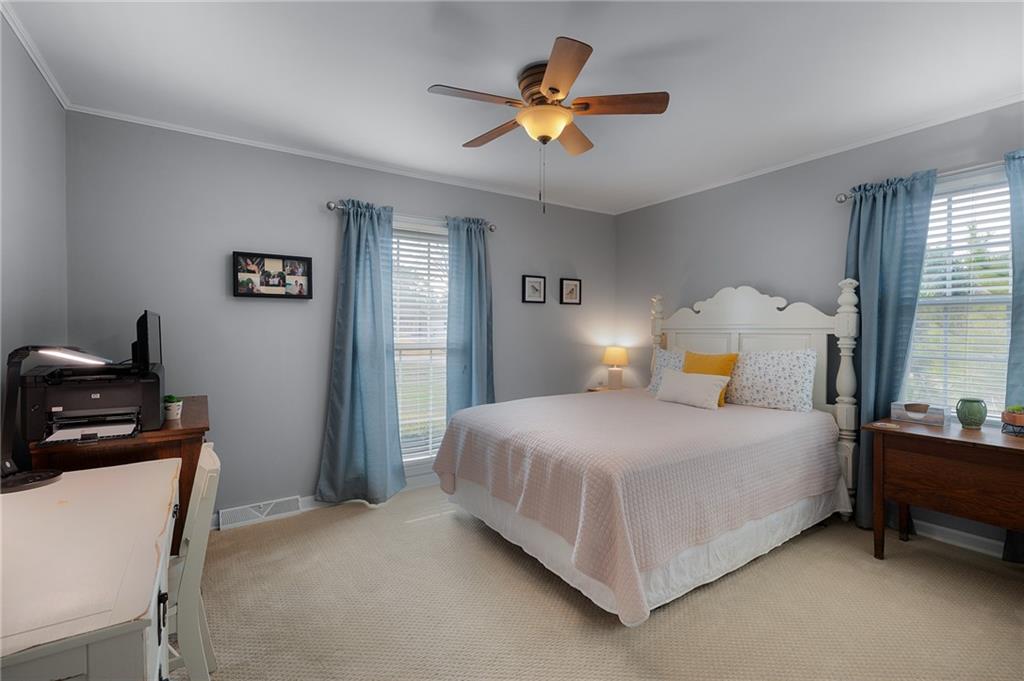 136 Meadow Lane Calhoun, GA 30701 - Photo 21 of 34 a bedroom with a bed and a chandelier