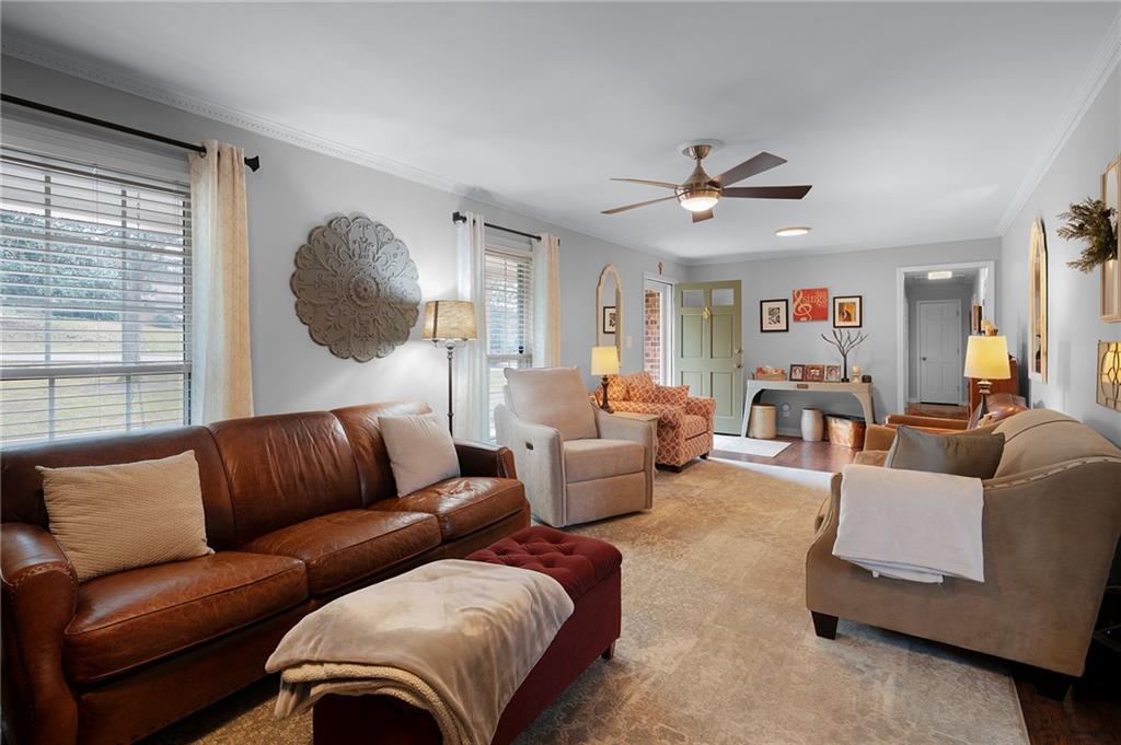136 Meadow Lane Calhoun, GA 30701 - Photo 6 of 34 a living room with furniture ceiling fan and a window