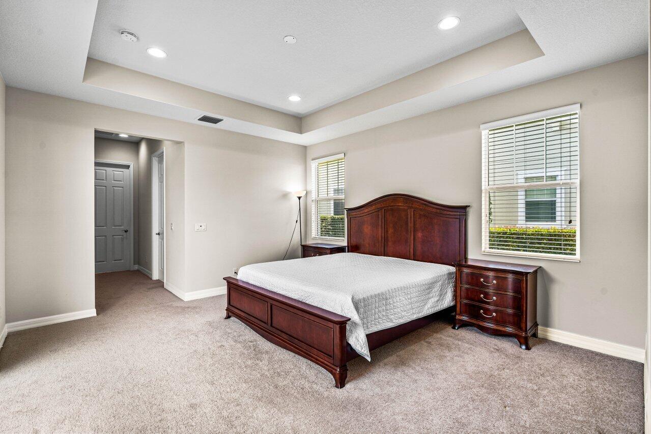 1131 North Prescott Drive Jupiter, FL 33458 - Photo 19 of 72 a spacious bedroom with a bed and a window