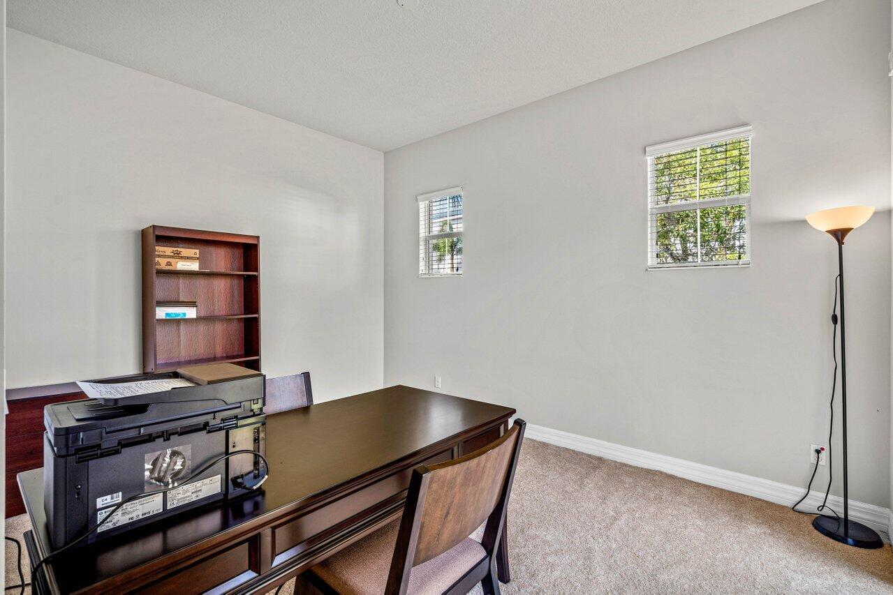 1131 North Prescott Drive Jupiter, FL 33458 - Photo 26 of 72 a room with a table and a window