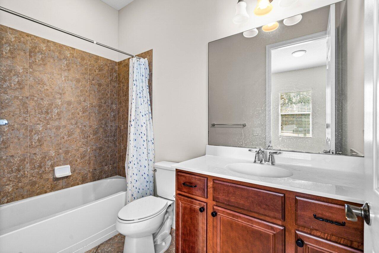 1131 North Prescott Drive Jupiter, FL 33458 - Photo 30 of 72 a bathroom with a sink toilet and shower