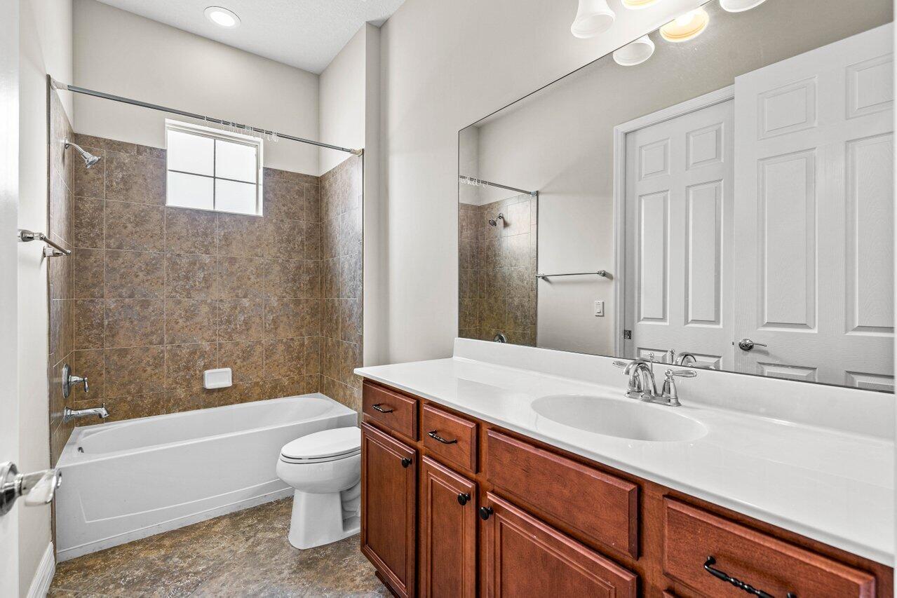 1131 North Prescott Drive Jupiter, FL 33458 - Photo 33 of 72 a bathroom with a sink a toilet and shower