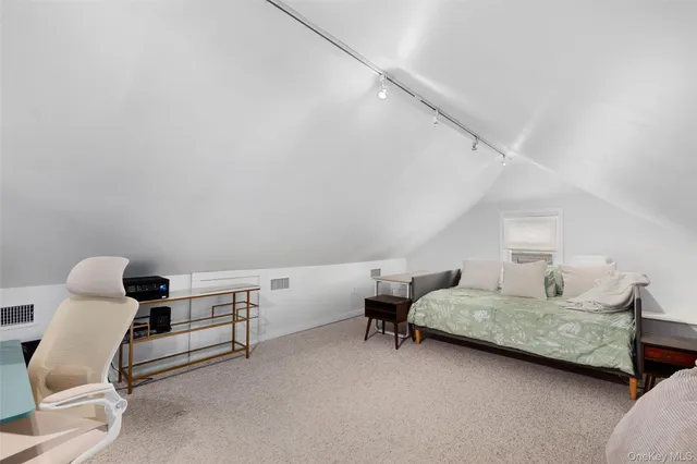 a bedroom with furniture and a chair