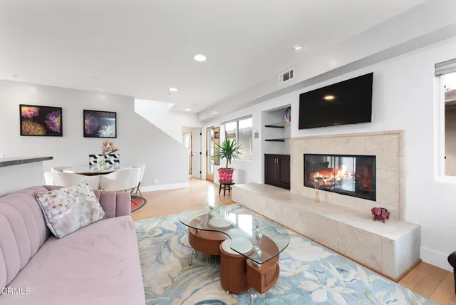a living room with furniture and a fireplace